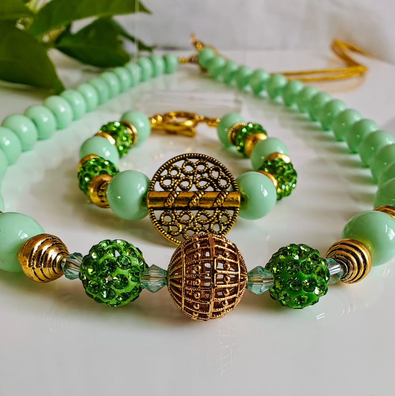 Jewelry making workspace with hands crafting jewelry, colorful beads, and jewelry-making supplies organized in compartments